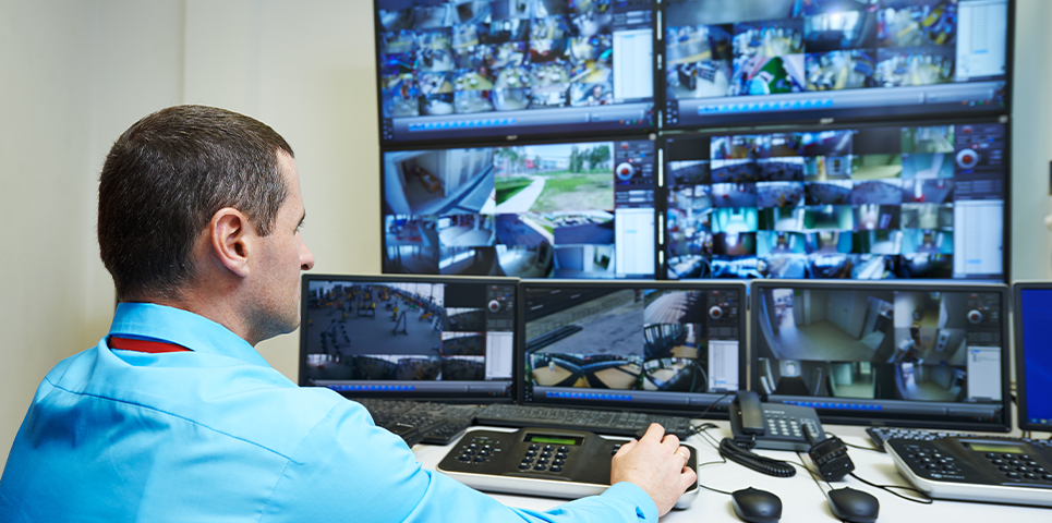 security expert checking video surveillance monitoring system
